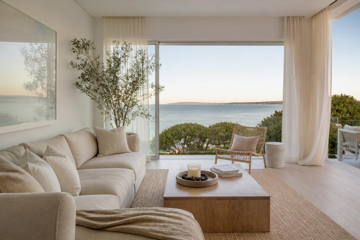 Light-filled coastal living room styled by Q + Co Design overlooking Port Phillip Bay